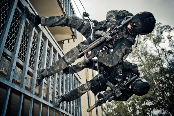 A picture of the Aus Federal Police abseiling in combat gear